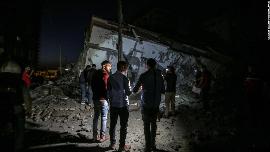 Palestinians inspect the rubble of the destroyed Hanadi tower after an Israeli airstrike in Gaza City on May 11.