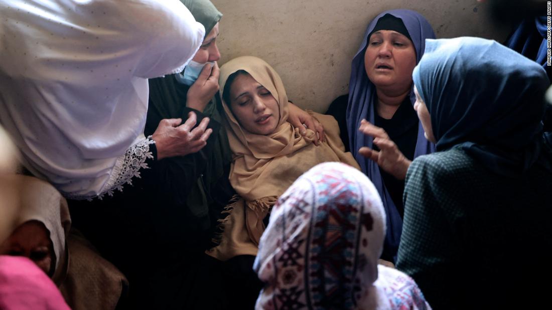 The mother of Palestinian Hussain Hamad, 11, is comforted by mourners during his funeral in Beit Hanoun, Gaza, on May 11. The boy was killed during fire between Israel and Gaza.