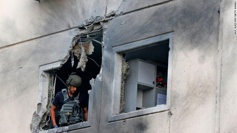 An Israeli soldier checks a damaged apartment building in Ashkelon on May 11.