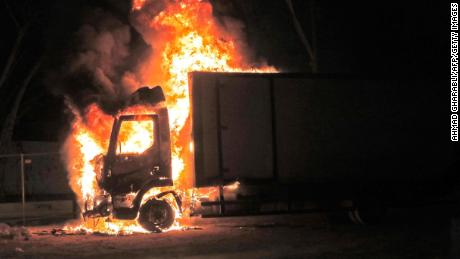 A truck burns near the entrance to the city of Lod.