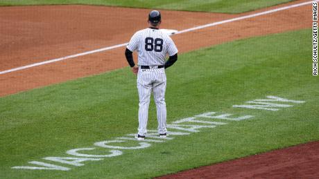 NEW YORK, NY - MAY 08: Third base coach Phil Nevin #88 of the New York Yankees stands near the coaching box as Vaccinate NY is painted on the field during a game against the Washington Nationals at Yankee Stadium on May 8, 2021 in New York City. A vaccination clinic is set up at the stadium for fans wishing to get vaccinated. (Photo by Rich Schultz/Getty Images)