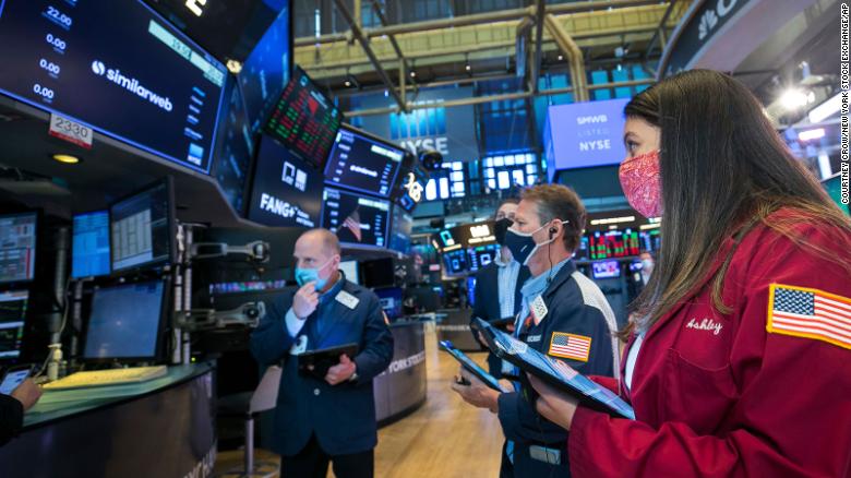 In this photo provided by the New York Stock Exchange, traders work around stock monitoring systems on the trading floor, Wednesday, May 12, 2021, in New York.