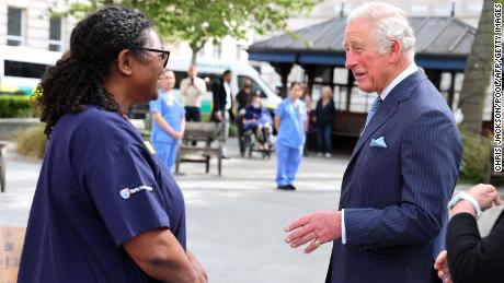 Charles speaks with nursing staff during a visit to St. Bartholomew&#39;s Hospital.