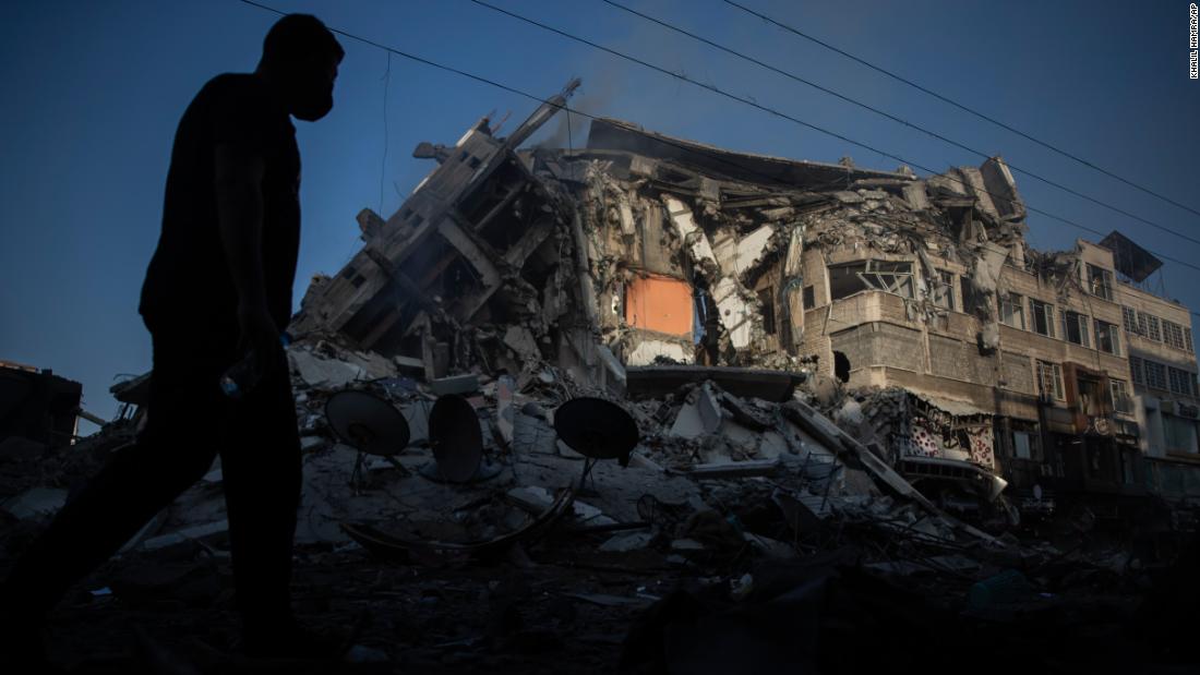 A Palestinian walks next to a building destroyed by Israeli airstrikes in Gaza City on May 13.