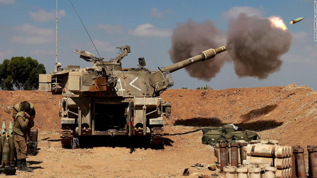 Israeli soldiers fire a 155mm self-propelled howitzer towards Gaza from their position near the southern Israeli city of Sderot on May 13.