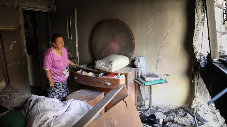 Julianna Sror views the damage to her apartment on May 13 after it was hit by a rocket in Petah Tikva, Israel.