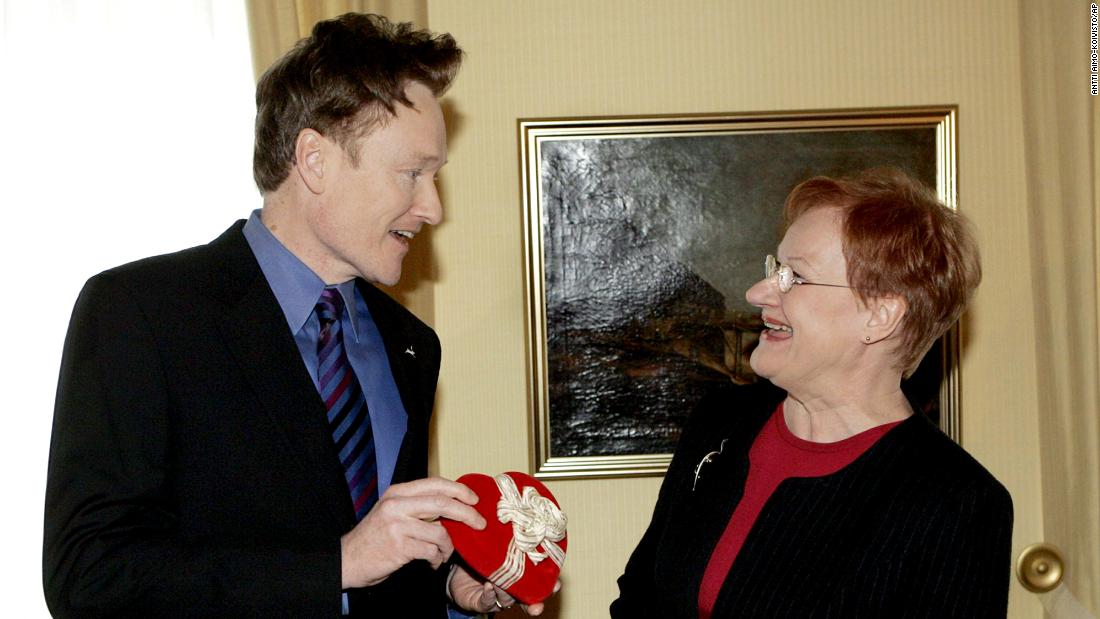 O&#39;Brien hands a Valentine&#39;s Day present to Finnish President Tarja Halonen as he visited the presidential palace in Helsinki in 2006. O&#39;Brien&#39;s resemblance to Halonen became a recurring bit on his show, and he eventually traveled to meet her and do a special episode from Finland.