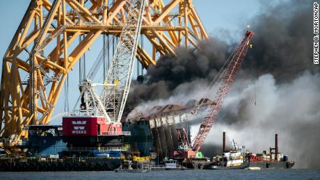 Smoke billows around the VB-10,000, a giant gantry crane being used to cut the wreckage of the capsized cargo ship Golden Ray on May 14, 2021..