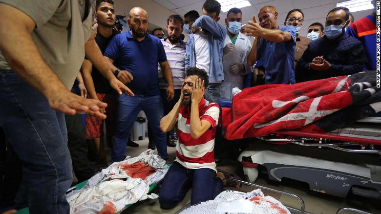 Relatives mourn over the bodies of the Abu Khatab family, who were killed in an Israeli airstrike, at the Shifa Hospital morgue in Gaza City on May 15.