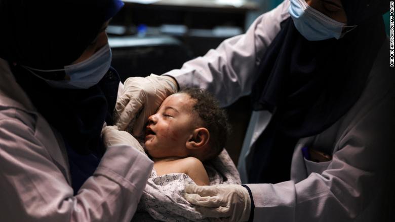A nurse holds an injured baby at Al-Shifa Hospital in Gaza City on May 15. The baby was pulled alive from a building destroyed by an Israeli airstrike, which killed 10 members of the child&#39;s family.