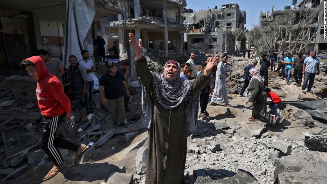A Palestinian woman reacts amid the damage caused by Israeli air strikes in Beit Hanun, Gaza, on May 14.
