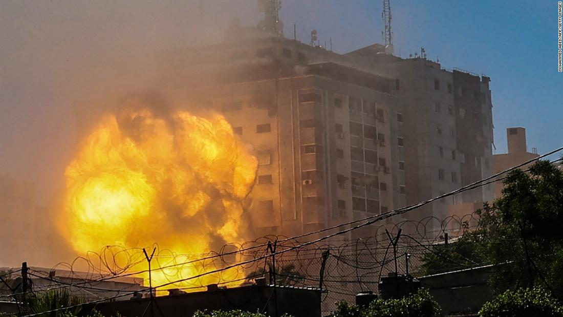 A ball of fire erupts from the Jala Tower, which houses the Associated Press, Al Jazeera, and other media offices, as it is destroyed by an Israeli airstrike in Gaza City, on Saturday, May 15.