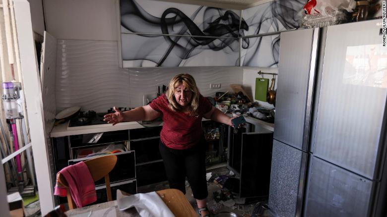 A woman reacts inside her kitchen on May 17 after a rocket from Gaza hit her apartment building in Ashdod, Israel.