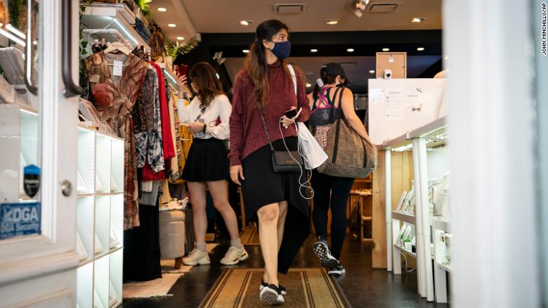 Customers wear masks in the retail shopping district in Manhattan on May 14, 2021