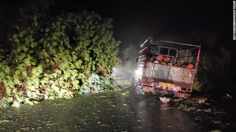 A truck loaded with oxygen cylinders stuck as trees fell due to Cyclone Tauktae, near Mahuva in Gujarat state, India, on May 17.
