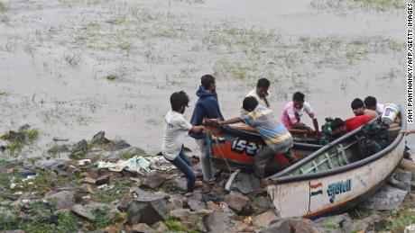 Fishermen pull  boats to shore during Cyclone Tauktae in Mahuva, Gujarat, India, on May 18. 