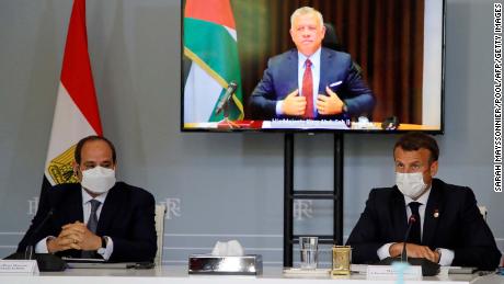 Egyptian President Abdel Fattah el-Sisi, left, and French President Emanuel Macron attend a video conference with Jordan&#39;s King Abdullah II ibn Al Hussein, on screen, to work on a ceasefire proposal at the Elysee Palace in Paris, on May 18.