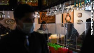 People sit at the bar behind a clear divider at Arnaldo Richard&#39;s Picos Restaurant as social distancing guidelines to curb the spread of the coronavirus disease (COVID-19) have been relaxed in Houston, Texas, U.S. May 4, 2020. REUTERS/Callaghan O&#39;Hare