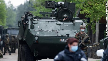 Soldiers park a tank at an entrance of Hoge Kempen National Park in northern Belgium on May 20.
