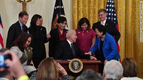 President Joe Biden hands over a pen to Hawaii&#39;s Democratic Senator Mazie Hirono after signing the Covid-19 Hate Crimes Act in the East Room of the White House in Washington, DC on May 20, 2021. 