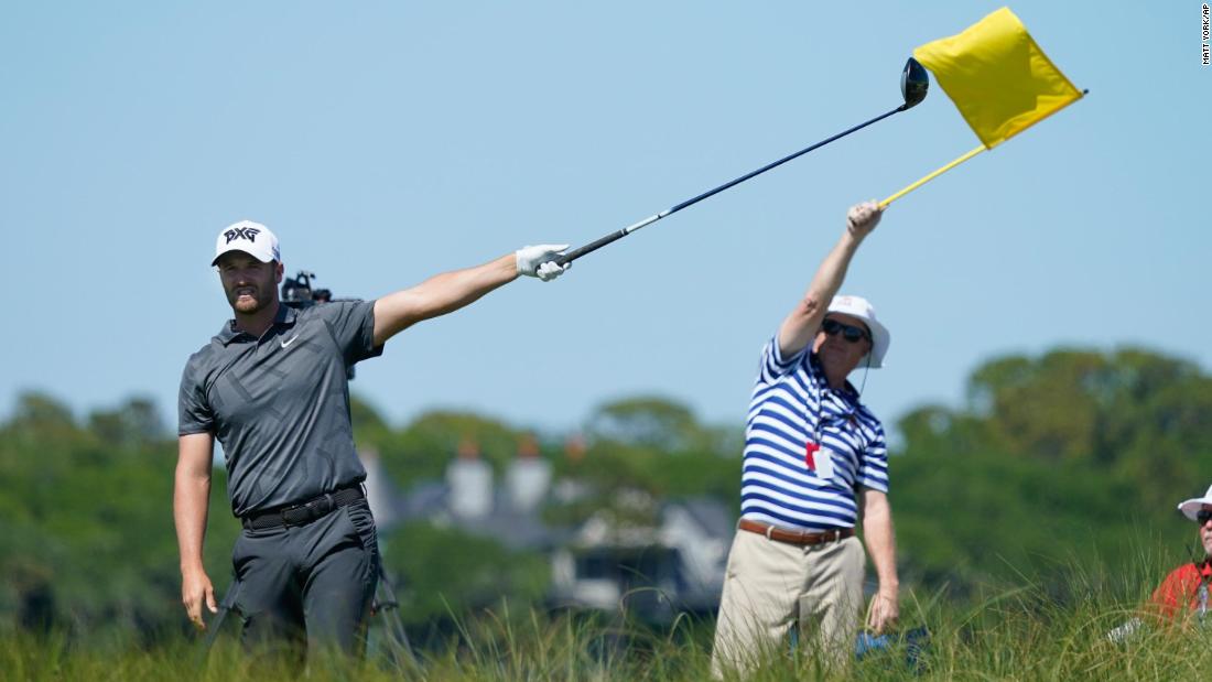 Wyndham Clark points to the direction of an errant tee shot on the eighth hole.