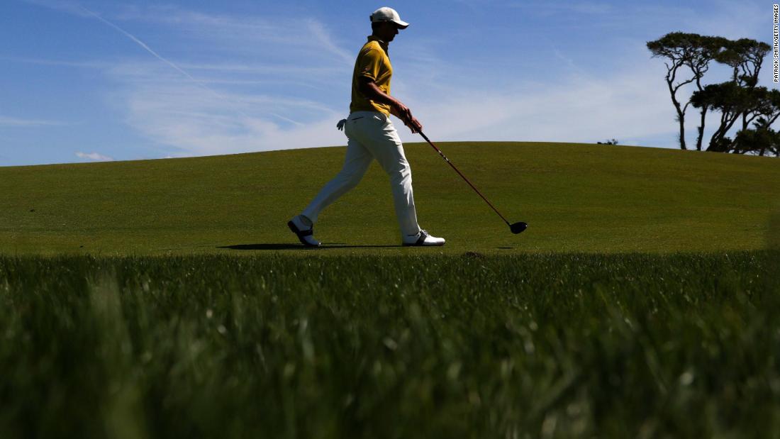 Adam Scott walks up the third fairway during the first round.