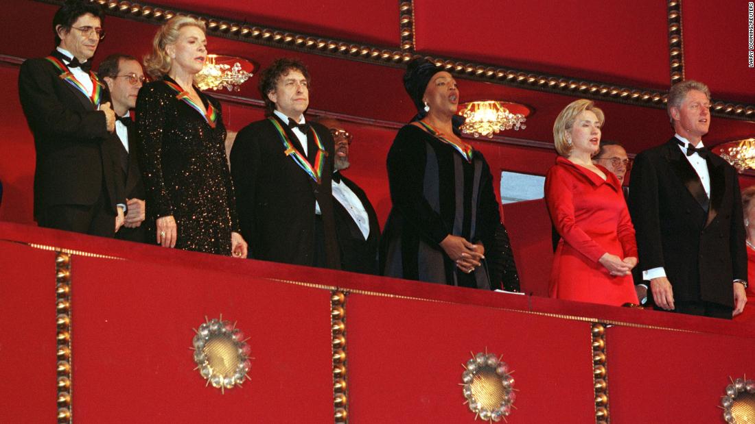 Dylan and other Kennedy Center honorees stand for the National Anthem with President Bill Clinton and first lady Hillary Clinton in 1997.