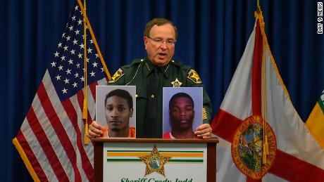 Polk County Sheriff Grady Judd displays mug shots of Chad Berrien, left, and Kevonte&#39; Wilson, who are both facing charges in connection with shooting of a 2-year-old girl by her 3-year-old brother.
