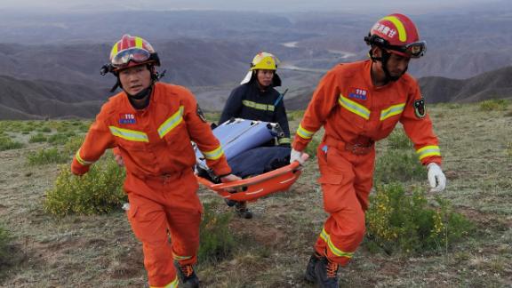 Les sauveteurs transportent du matériel pour rechercher des coureurs qui participaient à une course de montagne de 100 kilomètres lorsque des intempéries ont frappé la région, tuant au moins 21 personnes près de la ville de Baiin, dans la province du Gansu, au nord-ouest de la Chine. 