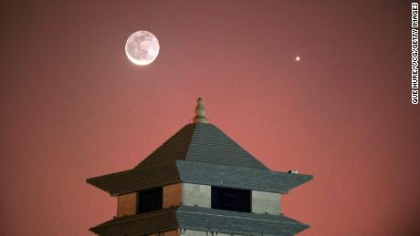 Venus appears in the night sky near a crescent moon on November 13, 2020, in the Korla, Xinjiang Uygur Autonomous Region of China. 