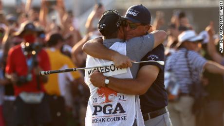 Mickelson celebrates with brother and caddie Tim Mickelson on the 18th green after winning during the 2021 PGA Championship.