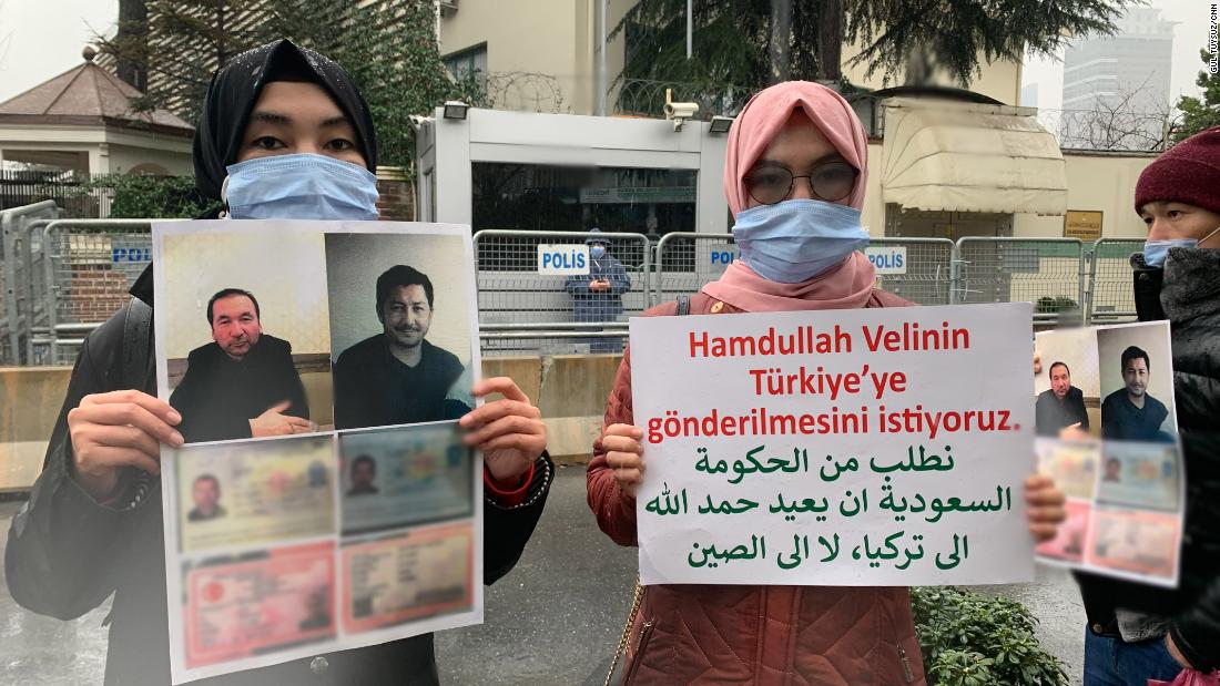 Nuriman Veli, second from left, and her sister protesting the disappearance of their father and his friend, pictured on the placard, outside Istanbul&#39;s Saudi consulate on February 12. CNN has blurred a portion of the photo to protect the men&#39;s personal details.