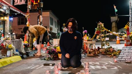 Courteney Ross, girlfriend of George Floyd, lays candles in the intersection of 38th St. &amp; Chicago Ave on March 29, 2021 in Minneapolis, Minnesota.