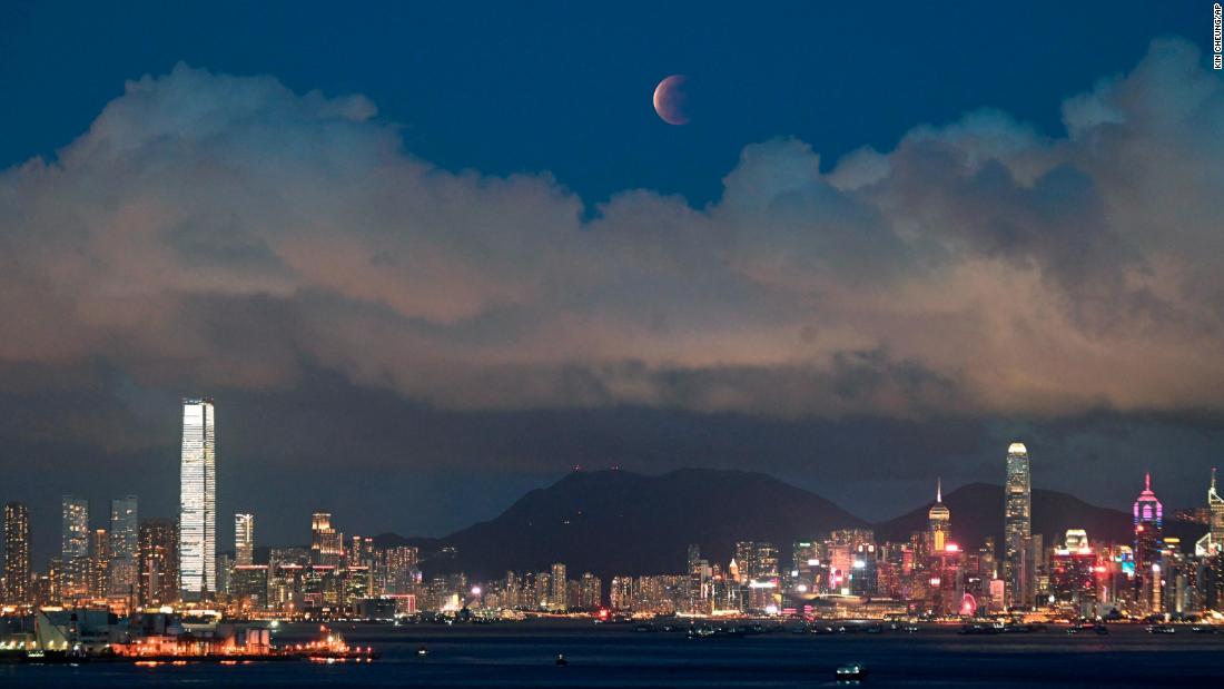 The moon rises over the Victoria Harbour in Hong Kong.