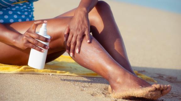 Woman applying sunscreen