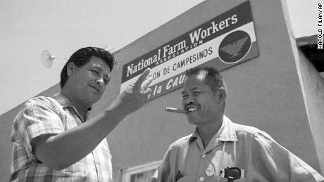 Larry Itliong, right, a Filipino-American labor leader and organizer with United Farm Workers leader Cesar Chavez, left, in front of union headquarters.