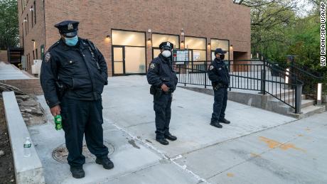 Police officers stand guard outside the Young Israel of Riverdale synagogue in the Bronx last month.