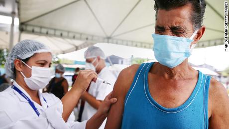 A Brazilian receives his Covid-19 vaccination at a health center in Nova Iguacu this week. Covid-19 has now killed more than 1 million people in Latin America and the Caribbean, with nearly half of those deaths in Brazil. 