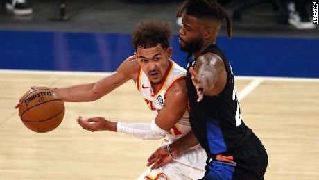 Atlanta Hawks&#39; Trae Young, left, tries to get past New York Knicks&#39; Reggie Bullock during the fourth quarter in Game 2 of the NBA playoffs. 