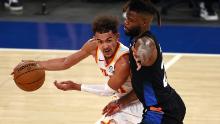 Atlanta Hawks' Trae Young, left, tries to get past New York Knicks' Reggie Bullock during the fourth quarter in Game 2 of the NBA playoffs. 