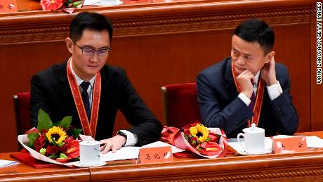 Alibaba's co-founder Jack Ma (R) looks at Tencent Holdings' CEO Pony Ma during a celebration meeting marking the 40th anniversary of China's &quot;reform and opening up&quot; policy at the Great Hall of the People in Beijing on December 18, 2018.