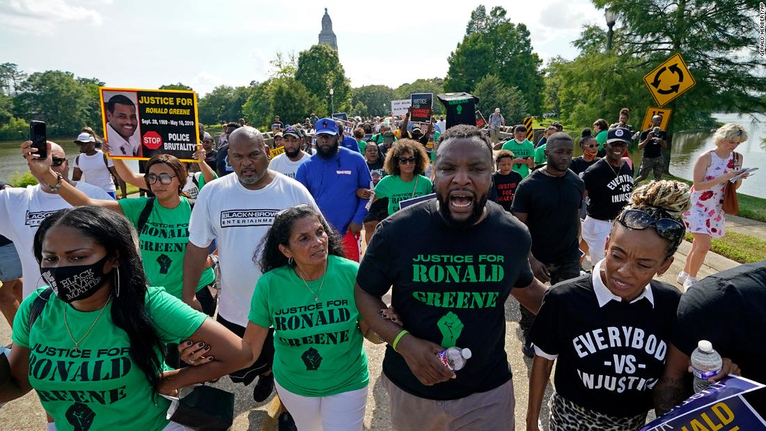 Ronald Greene's family marches arm in arm with supporters as they seek justice
