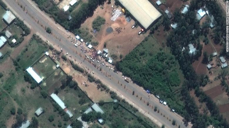 A crowd is seen outside the Guna distribution center on the outskirts of Shire, Ethiopia, in this satellite image captured on May 27. Detainees say they were beaten and tortured at the facility.