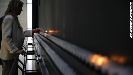 WASHINGTON, DC - JANUARY 26:  U.S. Susan Bourdeau lights a candle to commemorate International Holocaust Remembrance Day during a ceremony at the U.S. Holocaust Memorial Museum on the National Mall January 26, 2018 in Washington, DC. On January 27, 1945, Auschwitz-Birkenau, the largest Nazi concentration camp, was liberated by the Red Army and the date now marks the commemoration of the genocide that occurred during Word War II. The United Nations marked the day to remember the genocide that resulted in the death of an estimated 6 million Jewish people, 200,000 Romani people, 250,000 mentally and physically disabled people, and 9,000 homosexual men by the Nazi regime and its collaborators.  (Photo by Chip Somodevilla/Getty Images)