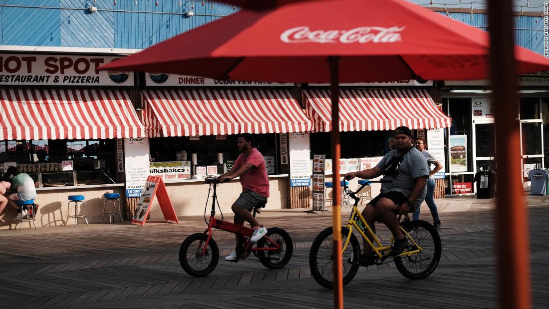 People ride along the boardwalk in Wildwood, New Jersey, on Thursday.