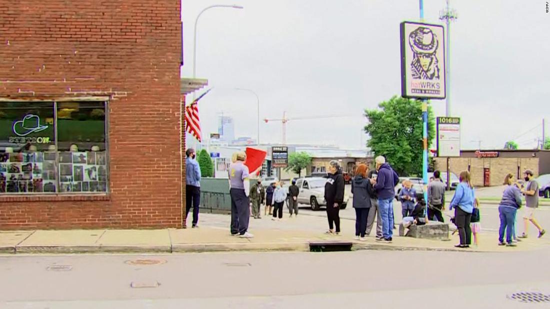 Demonstrators gather outside Nashville hat store that offered 'not vaccinated' yellow Star of David badges - CNN