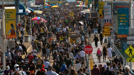 People crowd the Santa Monica Pier in Santa Monica, California, on Saturday, May 29, 2021. 