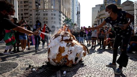 Demonstrators set fire to an effigy of Bolsonaro in Rio de Janeiro.
