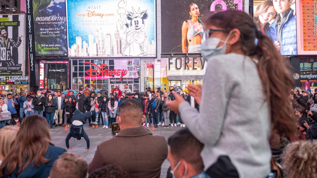 A large crowd gathers to watch a street performance in New York&#39;s Times Square on Saturday.