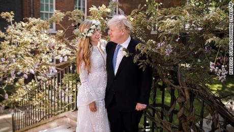 Boris and Carrie Johnson pose together in the garden of 10 Downing Street after their wedding.